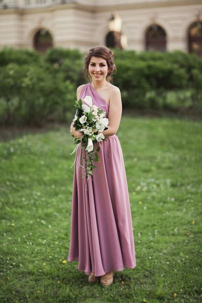 Beautiful bride, girl outdoors posing with bouquet - Fotoğraf, Görsel