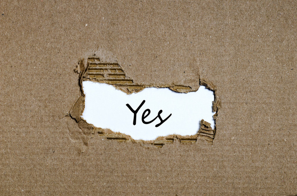 The word yes appearing behind torn paper - Photo, Image