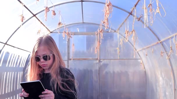 Young Farmer Girl in Greenhouse Calculates Profit - Záběry, video