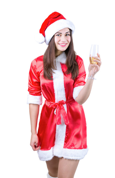 smiling girl in a dress and a Christmas hat with a glass in hand - Фото, изображение