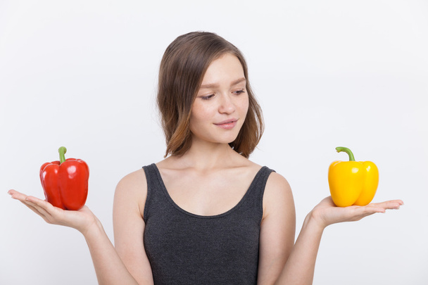 Slim girl with bell peppers - Photo, Image
