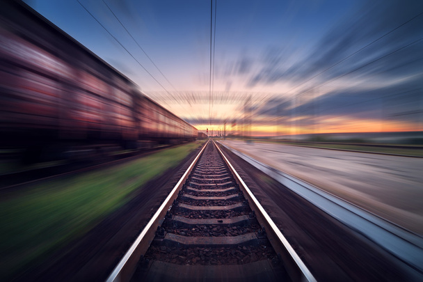 Treinstation met lading wagons in motion blur effect op sunse - Foto, afbeelding
