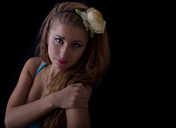 Beautiful young blond woman with flower in her hair - Foto, Bild