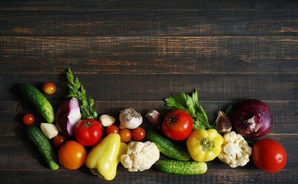 Fresh  vegetables on wooden background table from above. - Photo, Image