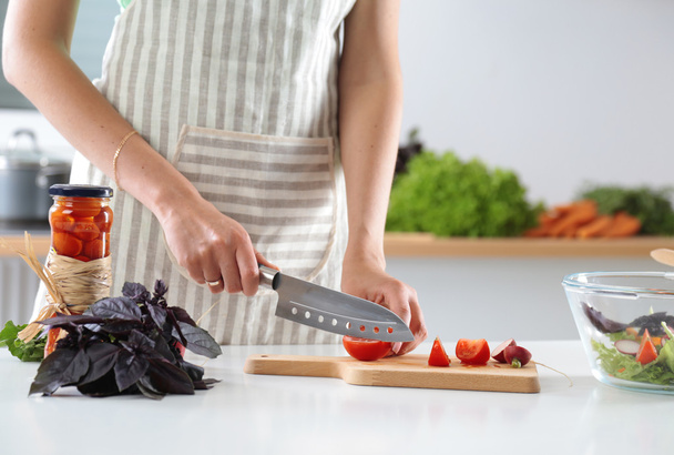 Cook's hands preparing vegetable salad - closeup shot - Fotó, kép