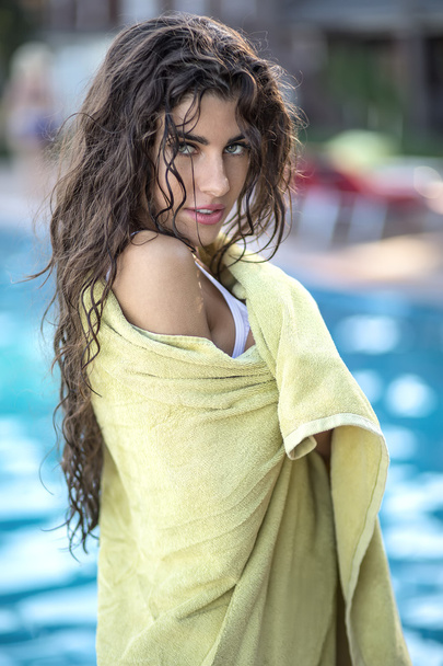 Girl in green towel near swimming pool - Valokuva, kuva