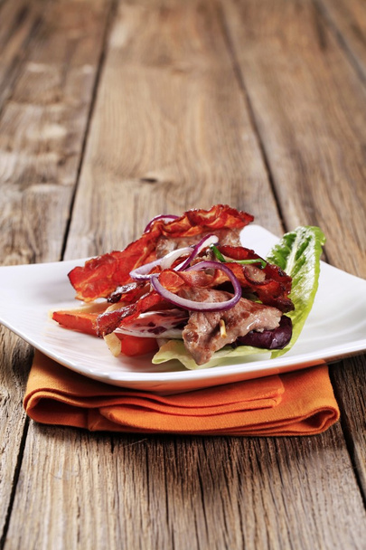Roast meat on skewer with crispy bacon - Photo, Image