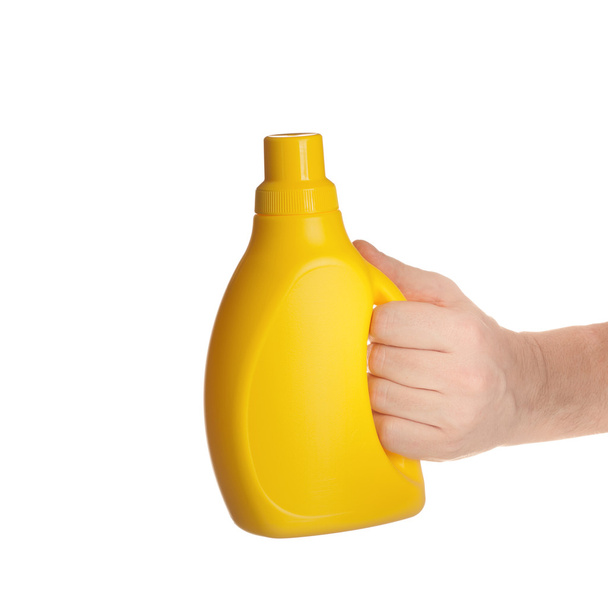 hand holding yellow plastic bottle isolated on white background - Photo, image