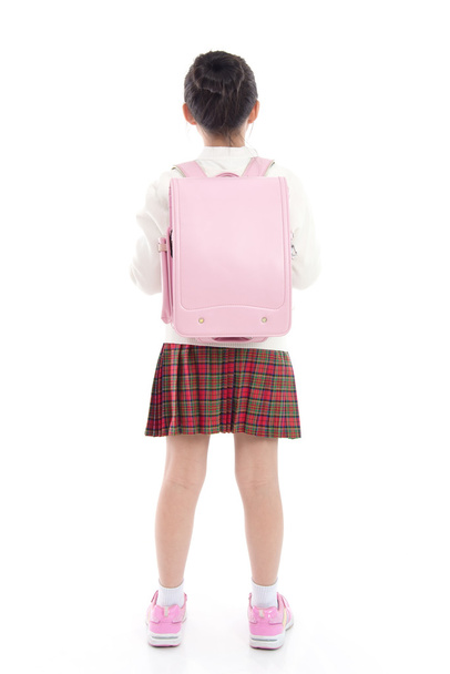 азиатский ребенок в школьной форме со школьной сумкой на белой спинке
 - Фото, изображение