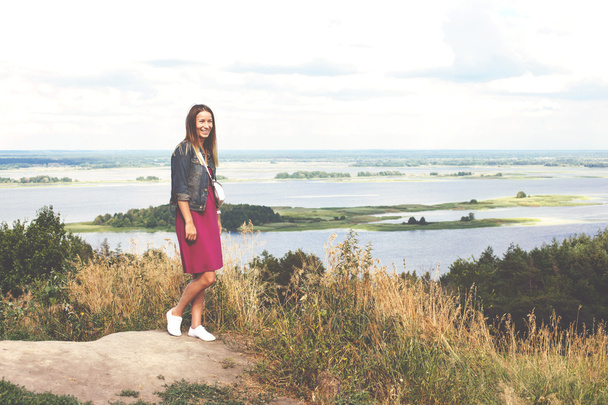 Happy girl standing on a mountaintop - 写真・画像