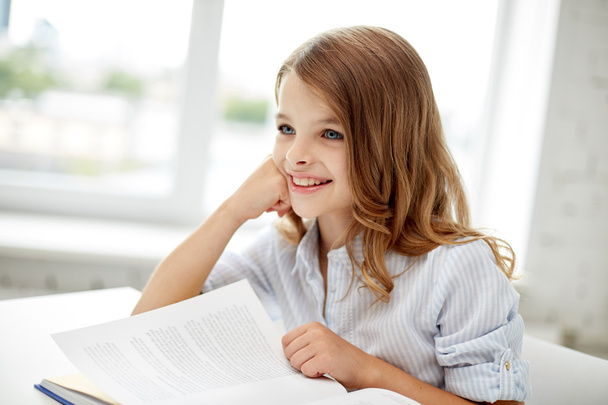happy student girl reading book at school - Foto, immagini