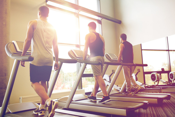 men exercising on treadmill in gym - Foto, immagini