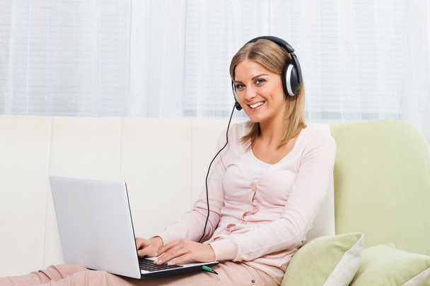 woman with laptop and headphones - Фото, изображение