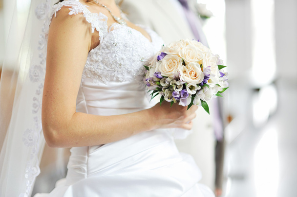 Bride holding wedding bouquet - Фото, изображение