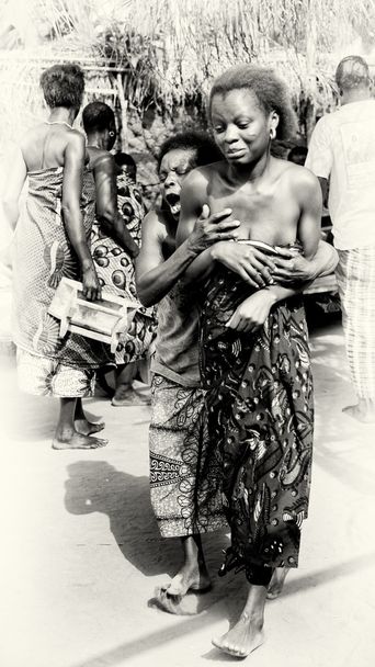 A lady from Togo helps her friend which has lost control under the voodoo enchantment - Photo, Image