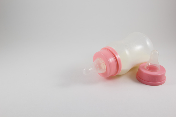 Baby bottle with milk and pacifier on a white background - Photo, Image