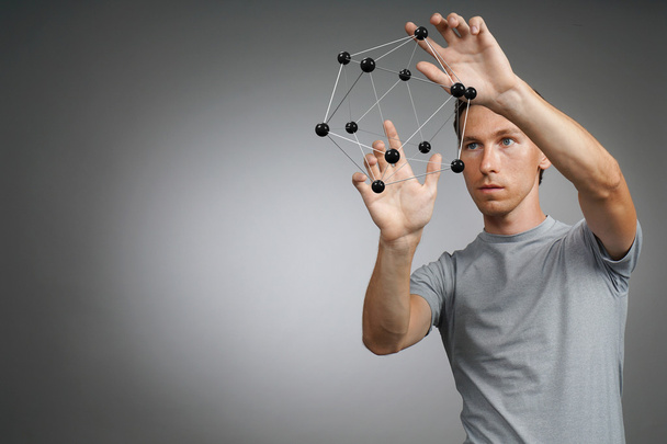 Man scientist working with model of molecule or crystal lattice. - Foto, Imagen