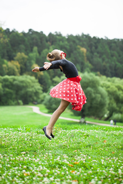 Little girl in a beautiful dress dancing  - Valokuva, kuva