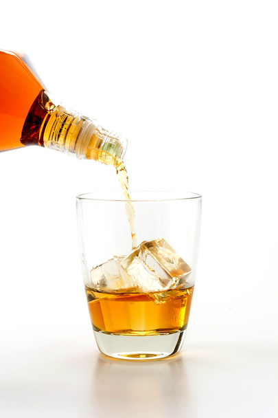 pouring wisky on white background - Foto, Imagen