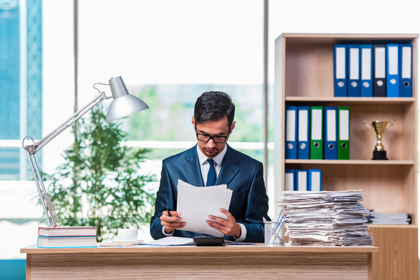 Young businessman in stress with lots of paperwork - Photo, Image