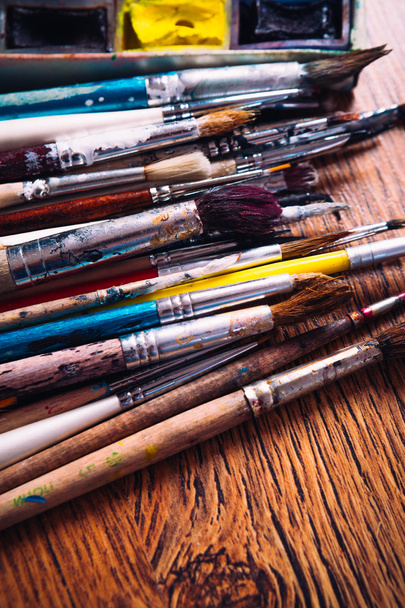 Many brushes for painting on wooden background - Fotoğraf, Görsel