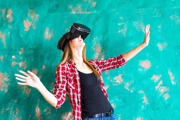 technology, entertainment and people concept - happy young woman with virtual reality headset or 3d glasses - Photo, Image