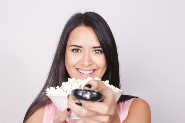 Young caucasian woman watching a movie / TV - Photo, Image