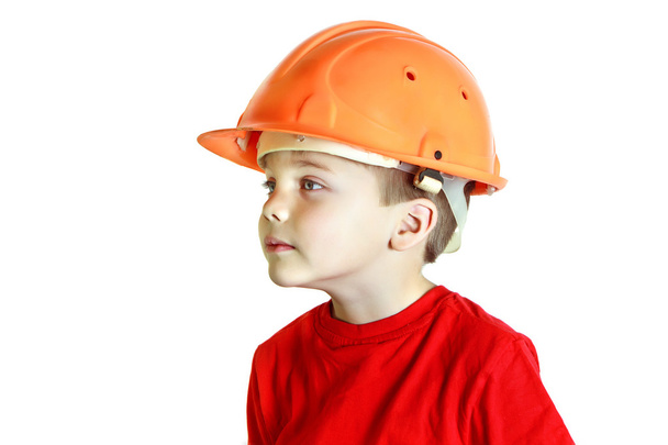 Little builder boy in the construction helmet - Foto, afbeelding