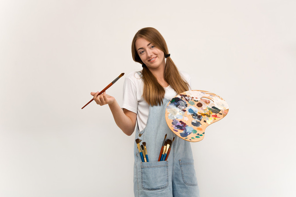 young artist holding a brush to paint and palette. - Foto, Imagem