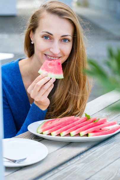 Young woman eating watermelon - Fotoğraf, Görsel