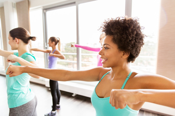 group of happy women working out in gym - Photo, image