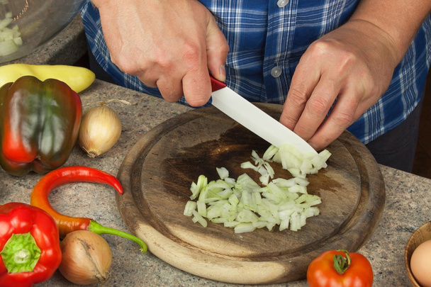 Het snijden van uien en tomaten. Dieet maaltijden bereiden. Chef-kok snijden van groenten voor een salade. - Foto, afbeelding
