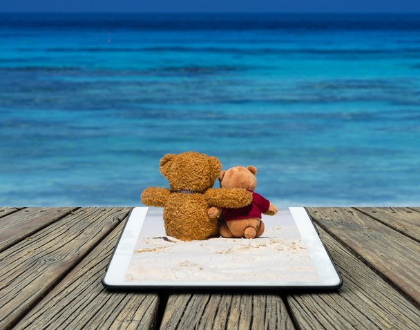Tablet with two teddy bears - Photo, Image