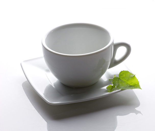 White cup with green leaf - Fotografie, Obrázek