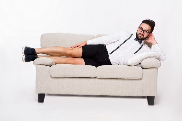 Smiling handsome man lying on couch - Foto, Imagem