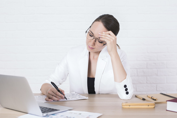 Pensive businesswoman doing paperwork - Фото, изображение