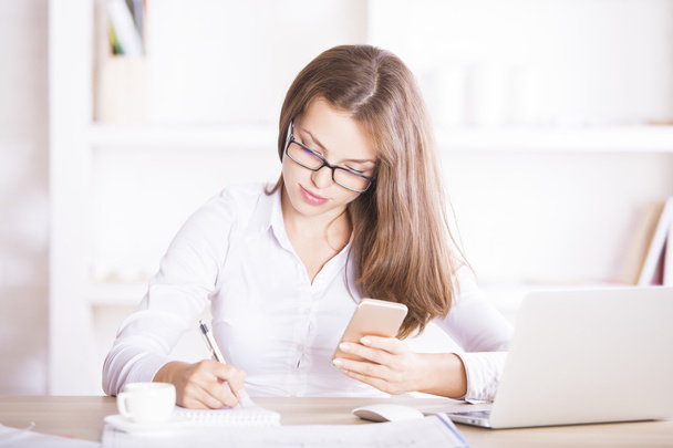 Attractive businesslady doing paperwork  - Photo, image