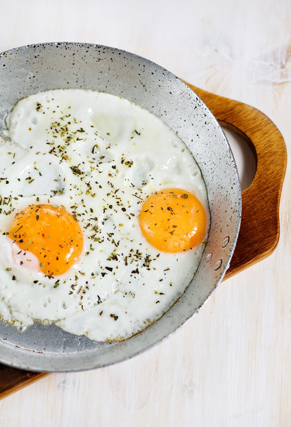 Fried eggs with spice on the frying pan - Photo, Image