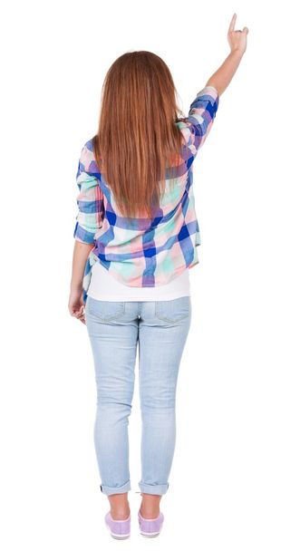 Back view of  pointing woman. beautiful redhead girl in jeans. - Fotoğraf, Görsel