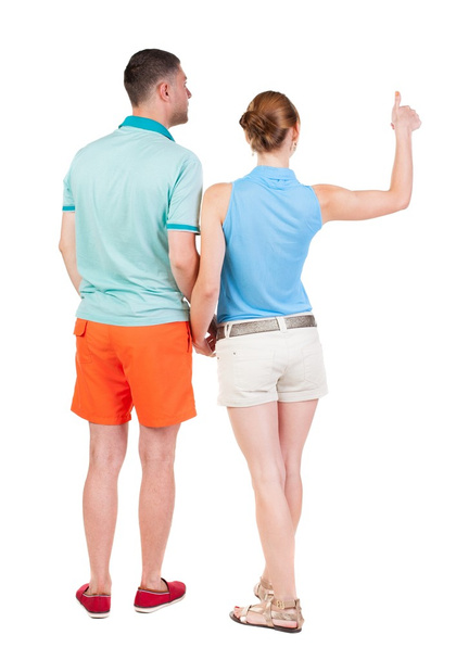 young couple pointing at wal Back view - Foto, imagen