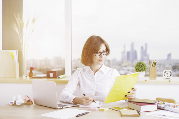 Attractive female doing paperwork - Photo, Image