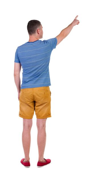 Back view of  pointing young men in  shorts. - Foto, imagen