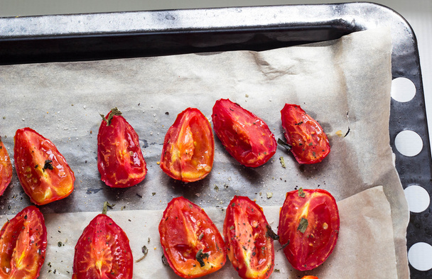 Sun dried tomatoes on white baking paper - Photo, image