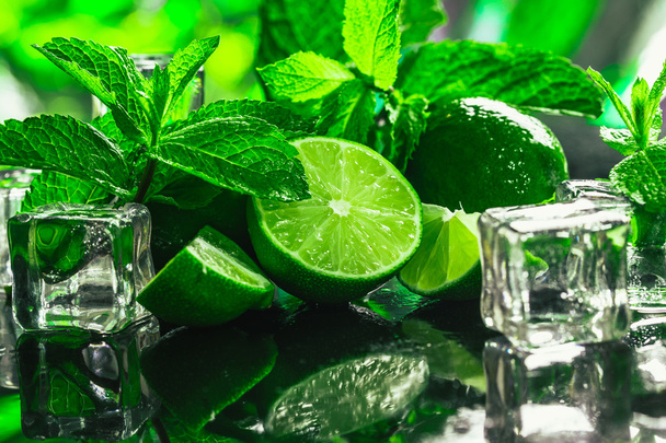 fresh green mint and lime ice cube close-up on a dark background - Фото, изображение