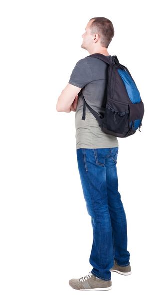 Back view of man with  backpack looking up. - Foto, Imagem