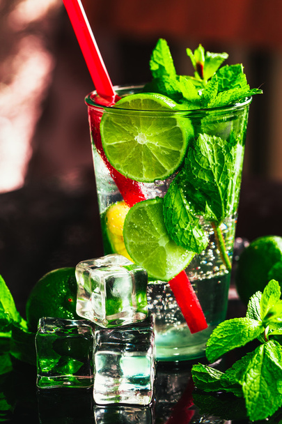 glass of mojito with lime and mint ice cube close-up red straw - 写真・画像