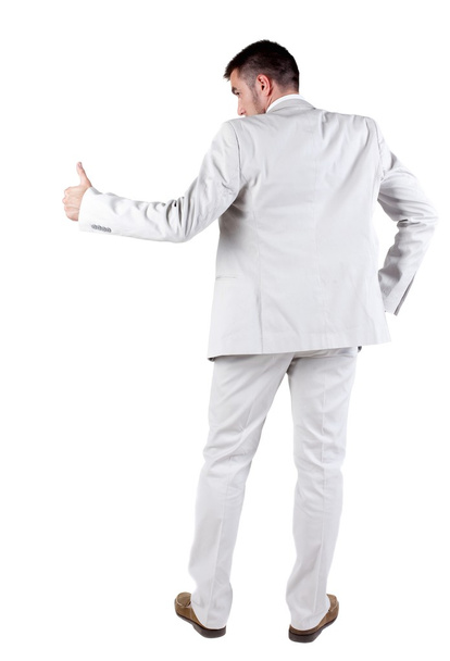 Back view of young business man in white suit going thumb up - Foto, Imagen
