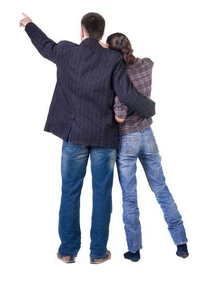 Young couple pointing at wall. Rear view. - Foto, imagen