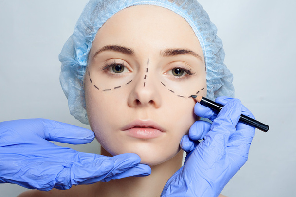 Beautiful young woman perforation lines plastic surgery operation - 写真・画像