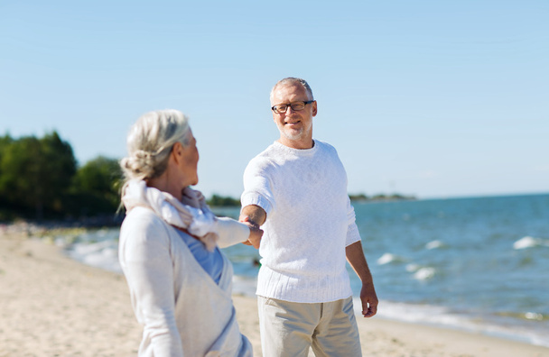 feliz pareja de ancianos tomados de la mano en verano playa
 - Foto, Imagen
